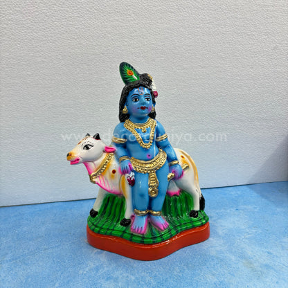 Cow Krishna paper mache golu doll – handmade Balakrishna idol with cow for Navaratri display