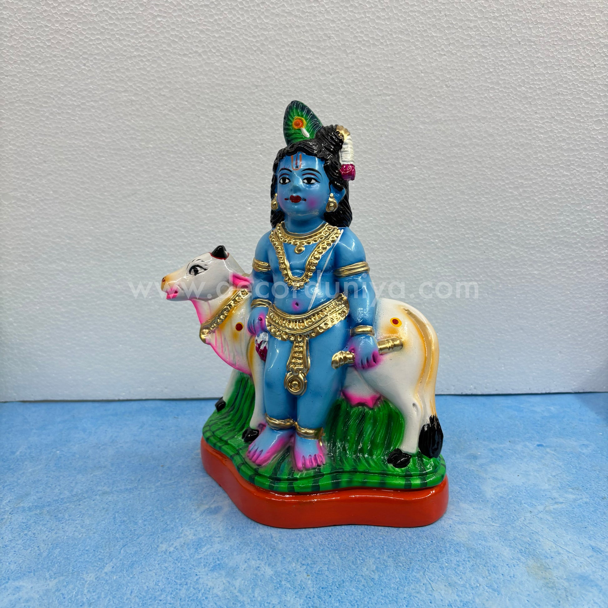 Cow Krishna paper mache golu doll – handmade Balakrishna idol with cow for Navaratri display